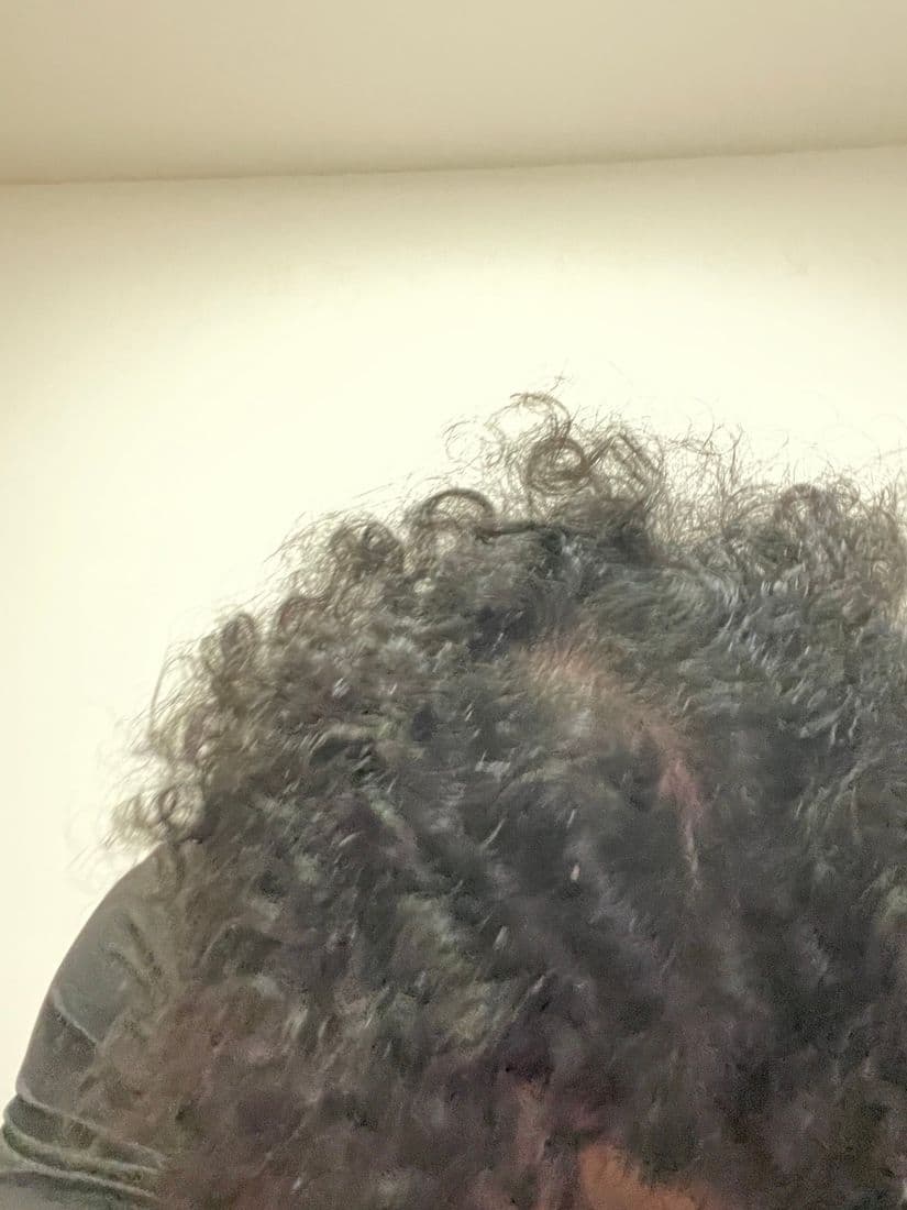 Top of the head with curls parted