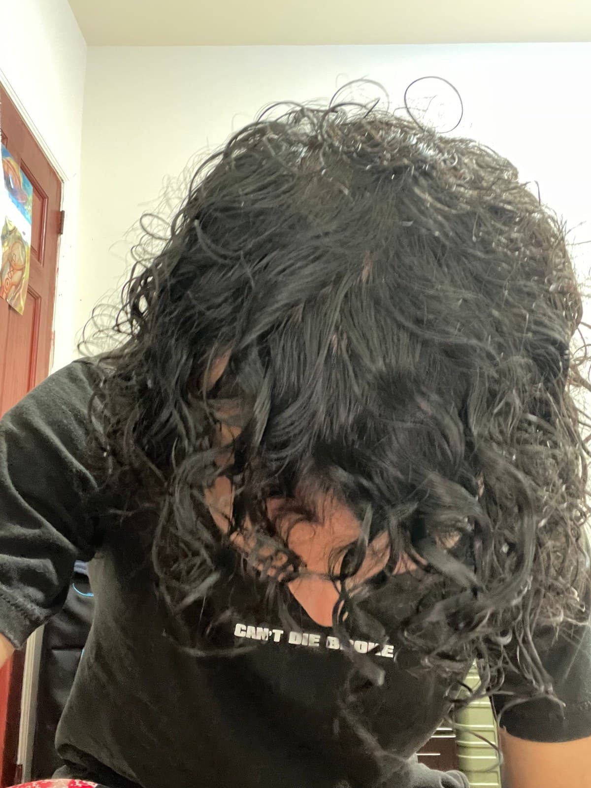 Back of the head with long curly hair before washing