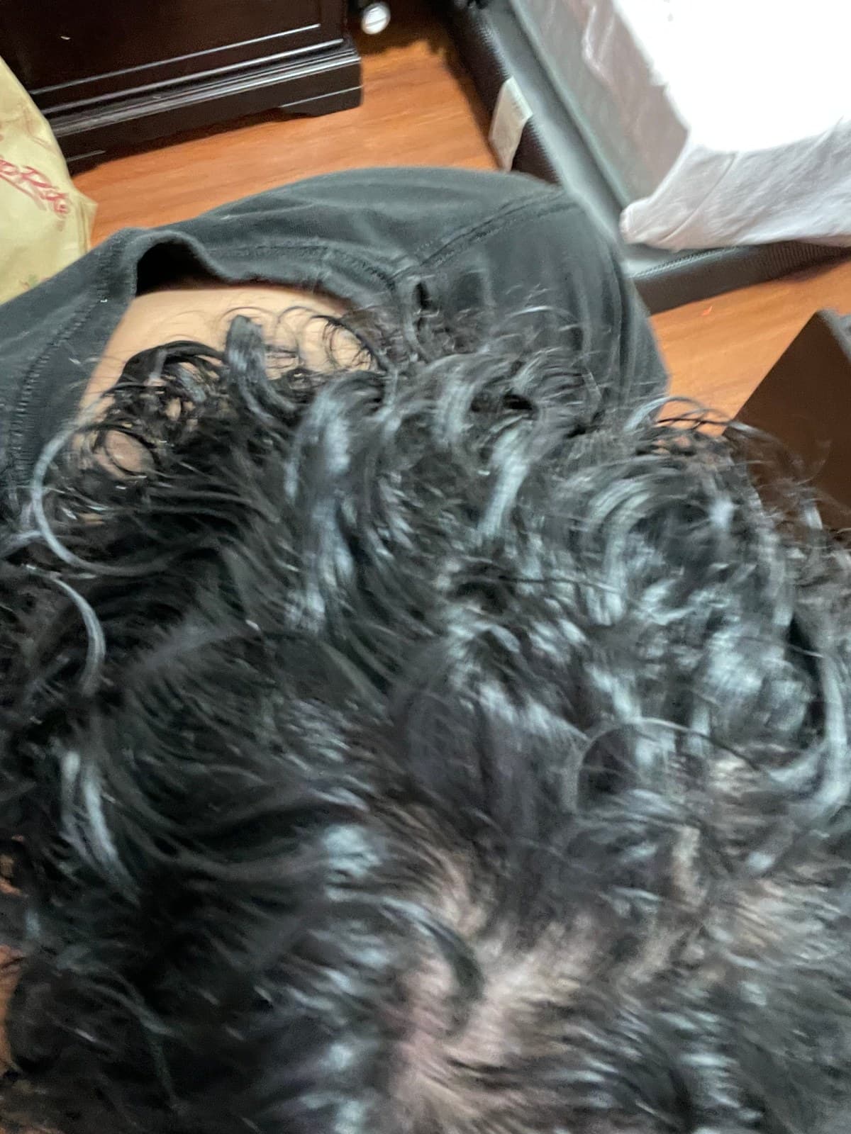 Scalp visible through parted wet curls