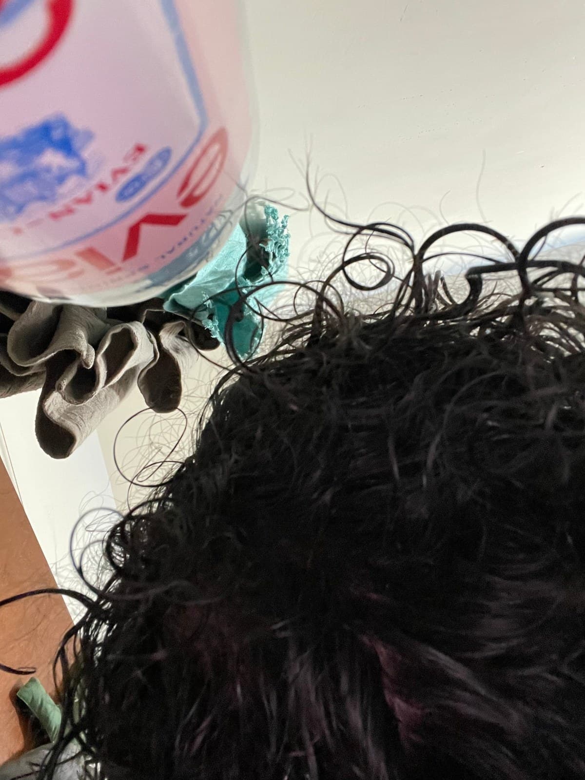 Close-up of wet curls with a product bottle nearby